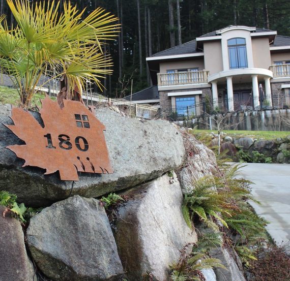 Rusted metal address sign made of iron